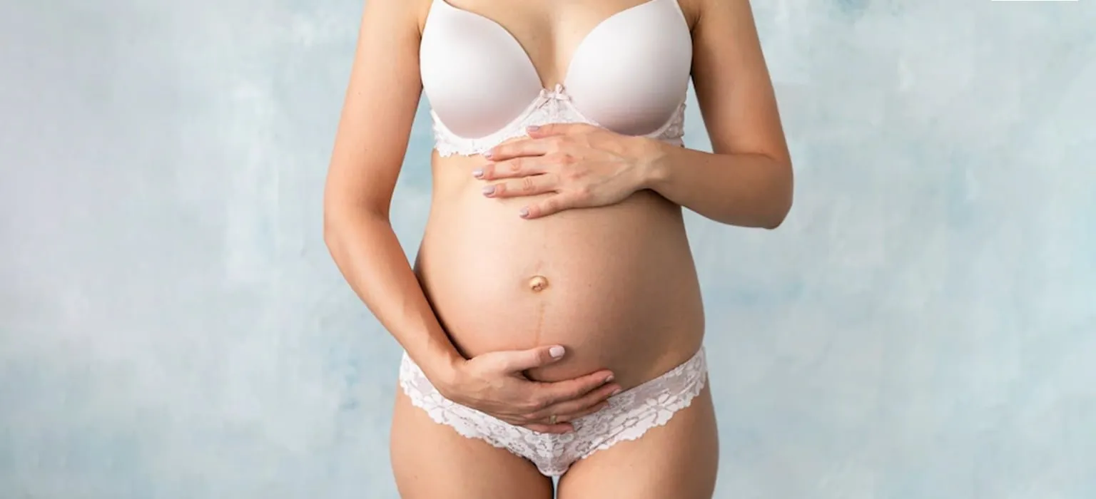 A pregnant woman holding her abdomen