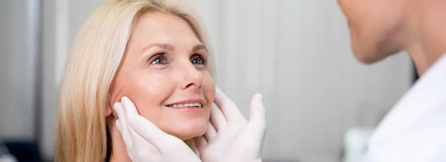 A doctor examining a woman's cheeks