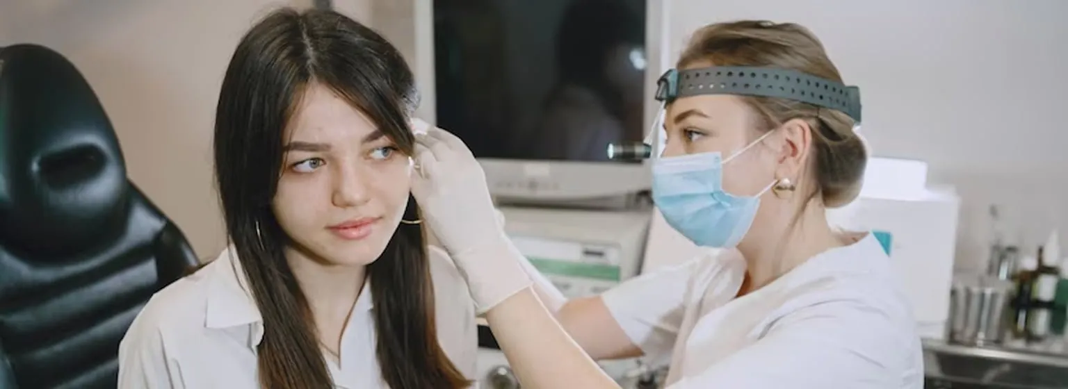 A doctor examining a young woman