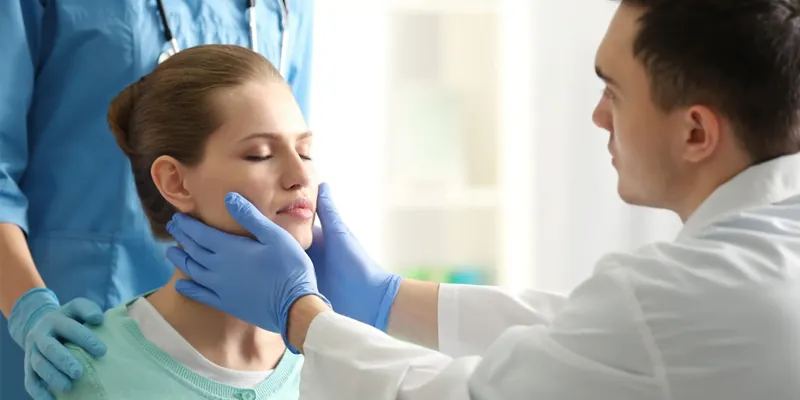 A doctor examining a woman's face